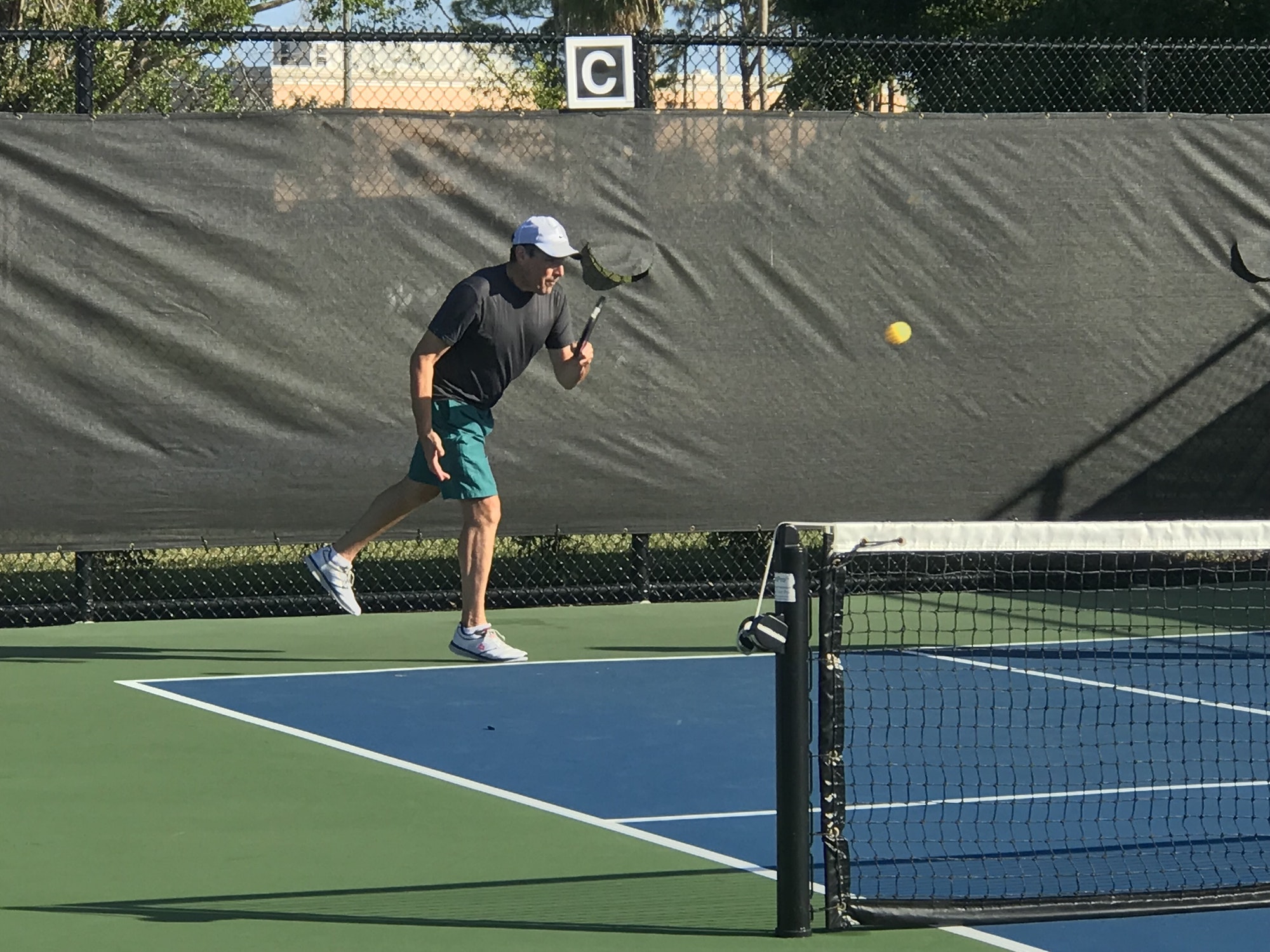 Active Baby Boomer staying active playing on an outside pickleball court